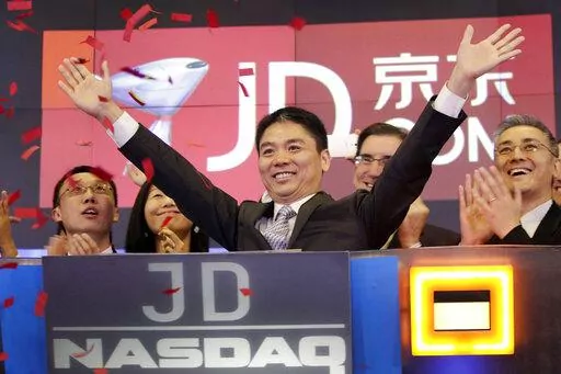 Liu Qiangdong, also known as Richard Liu, CEO of JD.com, raises his arms to celebrate the IPO for his company at the Nasdaq MarketSite, in New York on May 22, 2014. Liu has agreed to settle lawsuit from a former University of Minnesota student who alleges he raped her after a night of dinner and drinks in 2018 according to a statement released Saturday, Oct. 2, 2022. (AP Photo/Mark Lennihan, File)