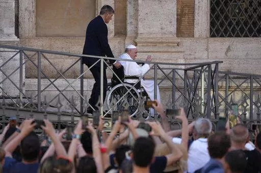 FILE-- Pope Francis greets the faithful as he leaves St. Mary Major Basilica after participating in a rosary prayer for peace, in Rome, Tuesday, May 31, 2022. Pope Francis canceled a planned July trip to Africa on doctors' orders because of ongoing knee problems, the Vatican said Friday, June 10, 2022, raising further questions about the health and mobility problems of the 85-year-old pontiff.  (AP Photo/Gregorio Borgia)