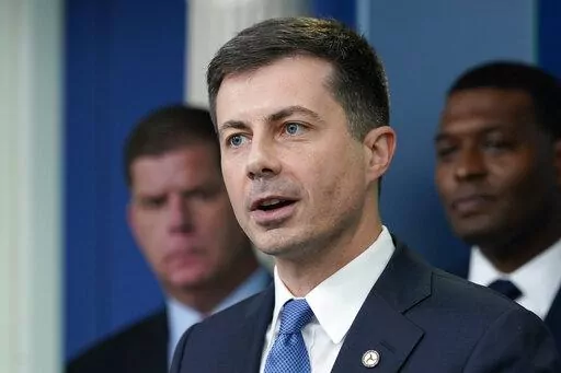 Transportation Secretary Pete Buttigieg, center, speaks during a briefing at the White House in Washington, May 16, 2022, as Labor Secretary Marty Walsh, left, and Environmental Protection Agency administrator Michael Regan, right, listen. Buttigieg says he is pushing airlines to hire more customer-service people and take other steps to help travelers this summer. (AP Photo/Susan Walsh, File)