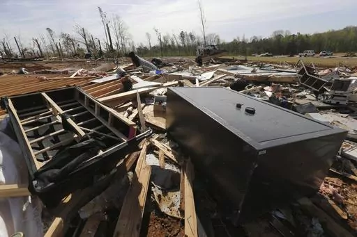 A gun vault and broken debris is all that is left of the home of Chad Mills along Hwy 15, Saturday, April 1, 2023 in Pontotoc, Miss. Storms that dropped possibly dozens of tornadoes killed multiple people in small towns and big cities across the South and Midwest, tearing a path through the Arkansas capital, collapsing the roof of a packed concert venue in Illinois, and stunning people throughout the region Saturday with the damage's scope.(Thomas Wells/The Northeast Mississippi Daily Journal vi