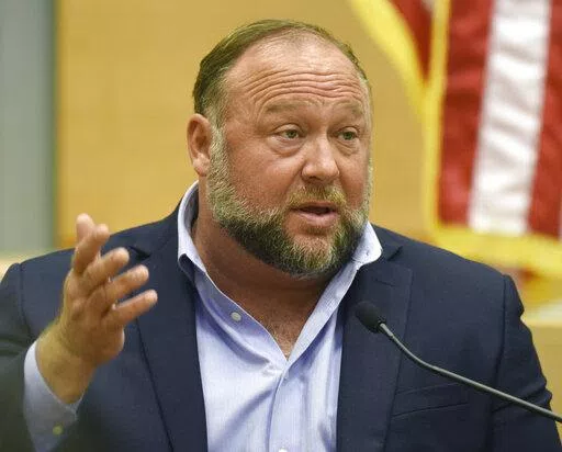 Conspiracy theorist Alex Jones takes the witness stand to testify at the Sandy Hook defamation damages trial at Connecticut Superior Court in Waterbury, Conn. Thursday, Sept. 22, 2022.  On Friday, Oct. 21, Jones has asked a Connecticut judge to throw out a nearly $1 billion verdict against him and order a new trial in a lawsuit by Sandy Hook families over Jones' lies that the 2012 Newtown school shooting was a hoax.(Tyler Sizemore/Hearst Connecticut Media via AP, Pool, File)