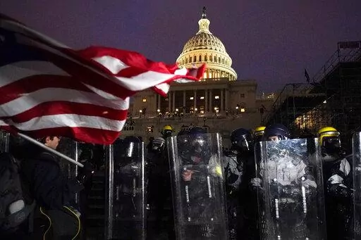 Police stand guard after a day of riots at the U.S. Capitol in Washington on Wednesday, Jan. 6, 2021. On Friday, Oct. 21, 2022, a Tennessee business owner who scaled a wall outside the U.S. Capitol was sentenced to four years in prison after he was convicted of five charges connected to the raid on Jan. 6, 2021, federal prosecutors said. (AP Photo/Julio Cortez, File)