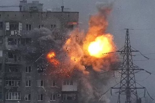 An explosion in an apartment building that came under fire from a Russian army tank in Mariupol, Ukraine, Friday, March 11, 2022. Ukraine’s military says Russian forces have captured the eastern outskirts of the besieged city of Mariupol. In a Facebook update Saturday, the military said the capture of Mariupol and Severodonetsk in the east were a priority for Russian forces. Mariupol has been under siege for over a week, with no electricity, gas or water. (AP Photo/Evgeniy Maloletka)