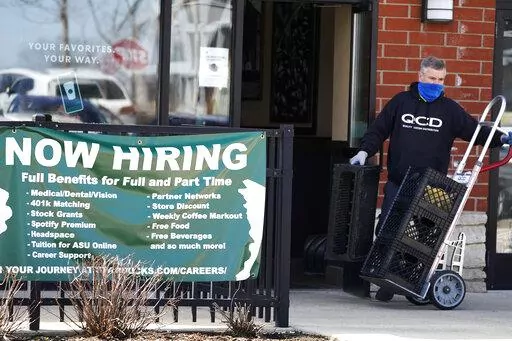 A hiring sign is displayed outside of a Starbucks in Schaumburg, Ill., Friday, April 1, 2022. America's employers added a healthy number of jobs last month, Friday, Sept. 2, yet slowed their hiring enough to potentially help the Federal Reserve in its fight to reduce raging inflation. The economy gained 315,000 jobs in August, a still-solid figure that pointed to an economy that remains resilient despite rising interest rates, high inflation and sluggish consumer spending. (AP Photo/Nam Y. Huh)
