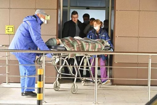 Medical staff carry an injured person on a stretcher at the emergency department of the First Republican Clinical hospital to evacuate to Moscow, in Izhevsk, Russia, Tuesday, Sept. 27, 2022. The plane of the Ministry of Emergency Situations will deliver victims of the shooting at school No. 88 in Izhevsk to Moscow hospitals. This was stated by the Presidential Commissioner for Children's Rights Maria Lvova-Belova. According to officials, 11 children were among those killed in the Monday morning 