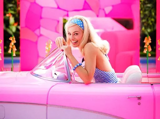 This image released by Warner Bros. Pictures shows Margo Robbie in character in the film "Barbie," releasing summer 2023. (Jaap Buitendijk/Warner Bros. Pictures via AP)
