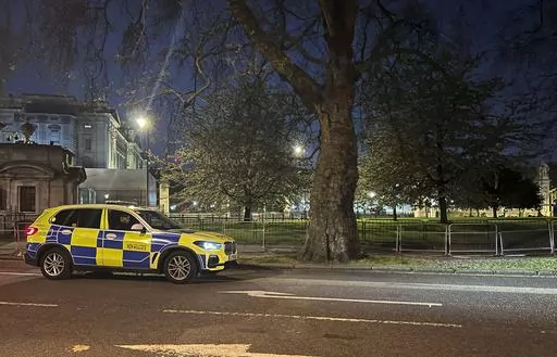 A police car outside Buckingham Palace, London, Tuesday, May 2, 2023. London police say a controlled explosion has been carried out as a precaution outside Buckingham Palace after a man was arrested on suspicion of possessing an offensive weapon. The Metropolitan Police force said officers arrested the man after he approached the palace gates on Tuesday night and threw items suspected to be shotgun cartridges onto the grounds. (Ben Roberts-Haslam/PA via AP)