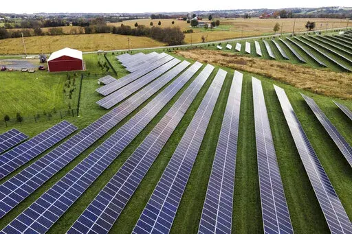 Farmland is seen with solar panels from Cypress Creek Renewables, Oct. 28, 2021, in Thurmont, Md. President Joe Biden plans to invoke the Defense Production Act to increase U.S. manufacturing of solar panels while declaring a two-year tariff exemption on panels from Southeast Asia. (AP Photo/Julio Cortez, File)