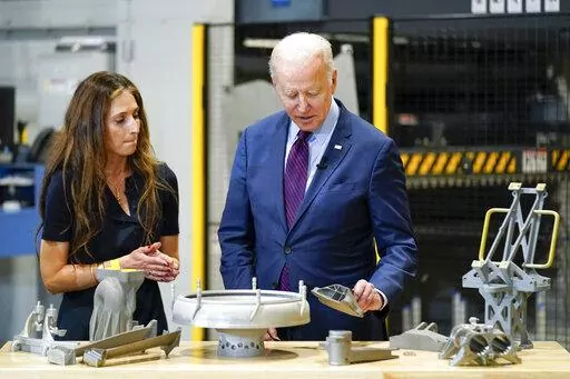 President Joe Biden speaks with Joanna Zelaya, CEO of Chicago Precision, during a tour at United Performance Metals in Hamilton, Ohio, Friday, May 6, 2022. (AP Photo/Andrew Harnik)