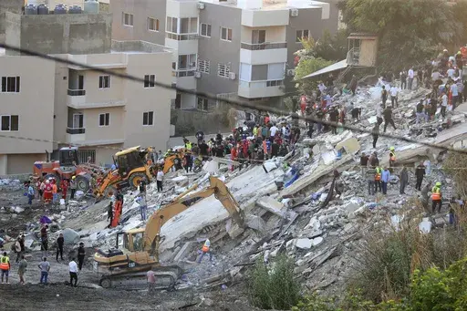 People and rescue teams search for victims after an Israeli airstrike hit two adjacent buildings, in Ain el-Delb neighbourhood east of the southern port city of Sidon, Lebanon, Sunday, Sept. 29, 2024. (AP Photo/Mohammed Zaatari, File)
