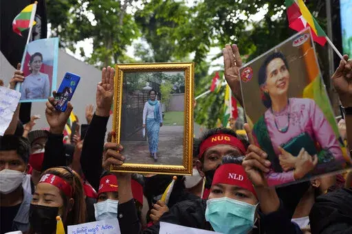 Myanmar nationals living in Thailand hold the pictures of deposed Myanmar leader Aung San Suu Kyi as they protest outside Myanmar's embassy in Bangkok, Thailand, Tuesday, July 26, 2022. International outrage over Myanmar’s execution of four political prisoners is intensifying with grassroots protests and strong condemnation from world governments. (AP Photo/Sakchai Lalit)