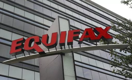 FILE- This July 21, 2012, file photo shows signage at the corporate headquarters of Equifax Inc. in Atlanta.  Credit bureau Equifax announced, Friday, Aug. 5, 2022,  that a computer coding error resulted in the miscalculation of credit scores for consumers in a three-week period between March 17 and April 6, 2022. For 300,000 consumers, the error shifted credit scores as much as 25 points. The changes to credit scores did not show up on credit reports. (AP Photo/Mike Stewart, File)