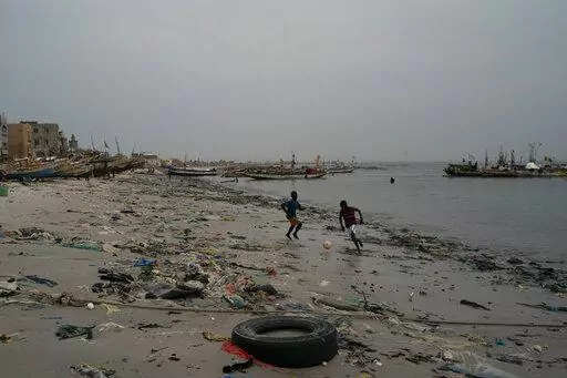 Boys play soccer among trash that litters the sand of Yarakh Beach in Dakar, Senegal, Nov. 8, 2022. Reducing waste while boosting recycling and reuse, known as the ‘circular economy,’ will be vital for halting the loss of nature, organizers of the World Circular Economy Forum said Wednesday, Dec. 7. (AP Photo/Leo Correa, File)