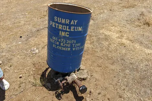 This photo provided by Clark Williams-Derry, shows a well leaking methane on May 10, 2022, in a neighborhood on the outskirts of Bakersfield, Calif. After 21 idle wells, including this one, were found to be leaking methane — some of them explosive levels of it — in May and June, the California Air Resources Board told The Associated Press that it’s not tallying leaks from idle wells. (Clark Williams-Derry via AP)