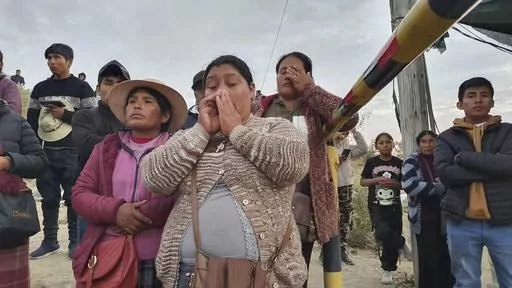 Relatives of trapped miners wait outside the SERMIGOLD mine in Arequipa, Peru, Sunday, May 7, 2023. The Public Ministry confirmed the death of 27 miners, who were trapped early Saturday morning due to an explosion in a tunnel inside the artisanal mine located in Yanaquihua district in Arequipa. (AP Photo/Fernando Mojito)
