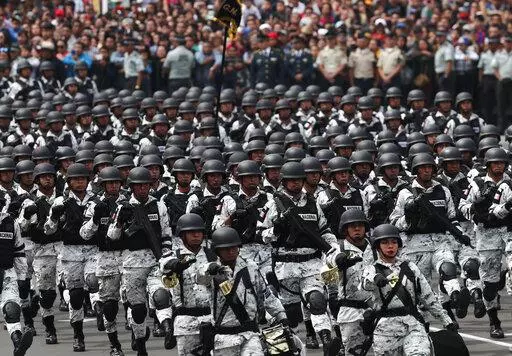 Members of Mexico's National Guard march in the Independence Day military parade, in the capital's main plaza, the Zocalo, in Mexico City, Sept. 16, 2019. Mexico’s President Andres Manuel Lopez Obrador has begun exploring plans to side-step congress to hand formal control of the National Guard to the army. That has raised concerns, because Lopez Obrador won approval for creating the force in 2019 by pledging in the constitution that it would be under nominal civilian control and that the army 