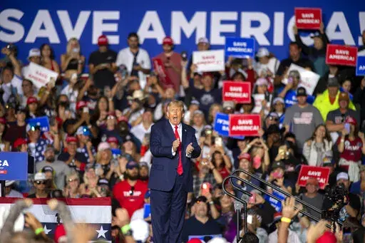 Former President Donald Trump applauds while speaking at a rally at the Minden Tahoe Airport in Minden, Nev., Oct. 8, 2022. At a rally for Nevada Republicans on Saturday, Trump argued against the federal probe into the storage of classified documents at his Mar-a-Lago estate by falsely suggesting that past presidents did the same thing. (AP Photo/José Luis Villegas, File)