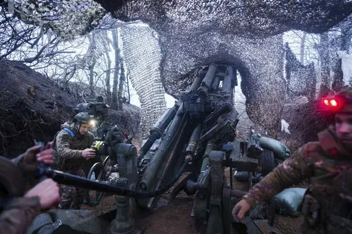 Ukrainian servicemen of 148th artillery brigade fire by a M777 howitzer towards Russian positions at the frontline on Velyka Novosilka direction, Donetsk region, Ukraine, Jan. 26, 2025. (AP Photo/Evgeniy Maloletka)