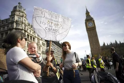 Demonstrators take part in the March of the Mummies national protest in central London, Saturday, Oct. 29 2022. The protest is organized by Pregnant Then Screwed to demand Government reform on childcare, parental leave and flexible working. (Aaron Chown/PA via AP)
