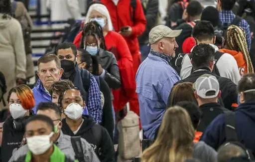 Crowds of the masked and the unmasked went through the security line at Hartsfield-Jackson International Airport on Tuesday, April 19, 2022 where the airport issued a statement Tuesday morning saying masks are now "optional for employees, passengers, and visitors" at the airport. "Although a mask mandate will no longer be enforced, employees, passengers, and visitors are reminded that masks continue to offer a level of protection against the COVID virus," the airport said. (John Spink/Atlanta Jo