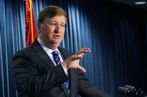 Mississippi Gov. Tate Reeves explains to reporters some of the line items that he vetoed from the appropriations allocated by the state Legislature, Thursday, April 28, 2022, in Jackson, Miss. (AP Photo/Rogelio V. Solis)
