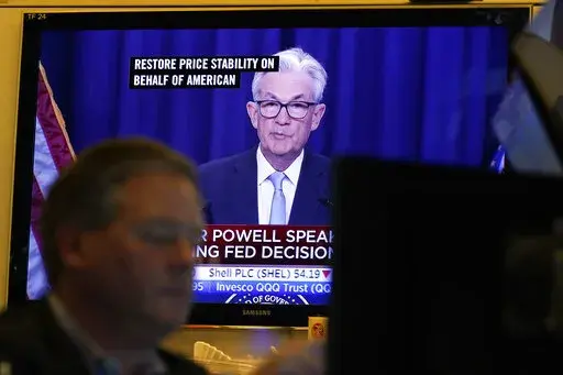 Federal Reserve Chairman Jerome Powell news conference is displayed on televisions while traders work on the floor at the New York Stock Exchange in New York, Wednesday, June 15, 2022. The Federal Reserve on Wednesday intensified its drive to tame high inflation by raising its key interest rate by three-quarters of a point — its largest hike in nearly three decades — and signaling more large rate increases to come that would raise the risk of another recession. (AP Photo/Seth Wenig)