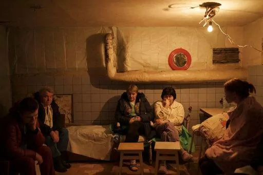 Hospital staff sit in a basement, used as a bomb shelter, during an air raid alarm in Brovary, north of Kyiv, Ukraine, Thursday, March 17, 2022. (AP Photo/Felipe Dana)
