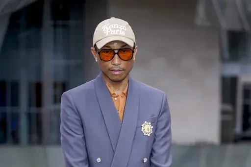 Pharrell Williams upon arrival at the Louis Vuitton Foundation on the eve of Paris Olympics opening ceremony, at the 2024 Summer Olympics, Thursday, July 25, 2024, in Paris, France. (AP Photo/Rebecca Blackwell)