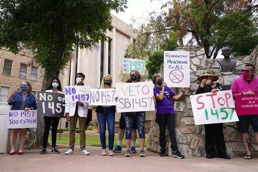 A number of Arizona reproductive health, rights, and justice advocates protest an abortion bill at the Arizona Capitol on Monday, April 26, 2021, in Phoenix. The Arizona Legislature has approved a ban on abortion after 15 weeks. The House approved the measure Thursday, March 24, 2022, a month after the Senate gave its ok, and it now heads to Republican Gov. Doug Ducey for his expected signature. (AP Photo/Ross D. Franklin, File)