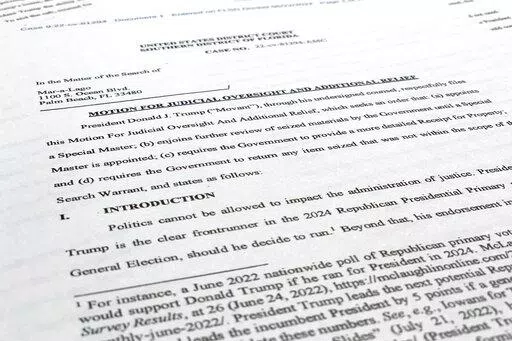 A court filing by lawyers for former President Donald Trump is photographed Monday, Aug. 22, 2022, as lawyers ask a federal judge to prevent the FBI from continuing to review documents recovered from his Florida estate until a neutral special master can be appointed. The attorneys asserted in a court filing, their first since the FBI search of Mar-a-Lago two weeks ago, that the sets of documents taken from the residence were "presumptively" covered by executive privilege. (AP Photo/Jon Elswick)