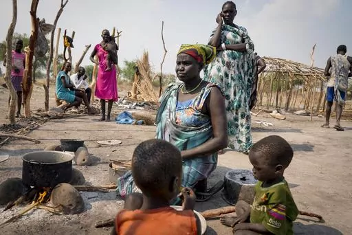 Martha Nyanguour, 50, who didn't have time to bury her husband, son or granddaughter when they were killed by gunfire in September, boils leaves in a pot for her family to eat, in Kowach village in Canal Pigi county, Jonglei State, South Sudan Friday, May 5, 2023. In 18 months the country is due to hold presidential elections, the culmination of a peace agreement signed nearly five years ago, and while large scale clashes have subsided, violence in parts of the country persists, with more people