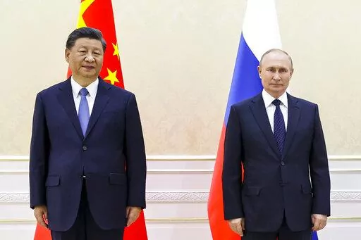 Chinese President Xi Jinping, left, and Russian President Vladimir Putin pose for a photo on the sidelines of the Shanghai Cooperation Organization (SCO) summit in Samarkand, Uzbekistan, Thursday, Sept. 15, 2022. (Alexandr Demyanchuk, Sputnik, Kremlin Pool Photo via AP)