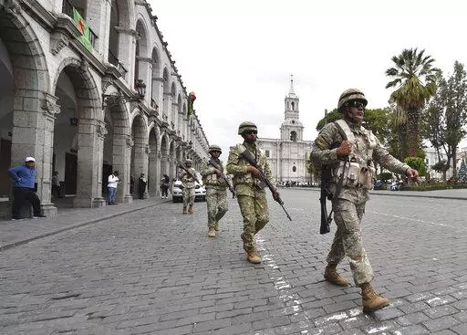 Soldiers patrol in Arequipa, Peru, Wednesday, Dec. 14, 2022. Peru’s new government declared a 30-day national emergency on Wednesday amid violent protests following the ouster of President Pedro Castillo, suspending the rights of “personal security and freedom” across the Andean nation. (AP Photo/Jose Sotomayor)
