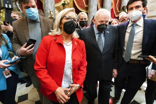 Rep. Liz Cheney, R-Wyo., vice chair of the House panel investigating the Jan. 6 U.S. Capitol insurrection, and her father, former Vice President Dick Cheney walk in the Capitol Rotunda at the Capitol in Washington, Thursday, Jan. 6, 2022. Rep. Liz Cheney has been setting multiple personal fund-raising records despite a GOP backlash for voting to impeach former President Donald Trump for the Jan. 6, 2021, insurrection at the U.S. Capitol and for not relenting in her public criticism of Trump. (AP