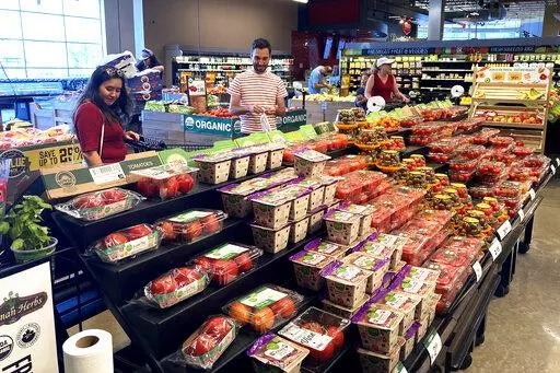 People shop at a grocery store in Glenview, Ill., Monday, July 4, 2022. The problems have hardly gone away. Inflation, still near a 40-year high, is punishing households. Rising interest rates have derailed the housing market and threaten to inflict broader damage. And the outlook for the world economy grows bleaker the longer the war in Ukraine drags on.  (AP Photo/Nam Y. Huh)