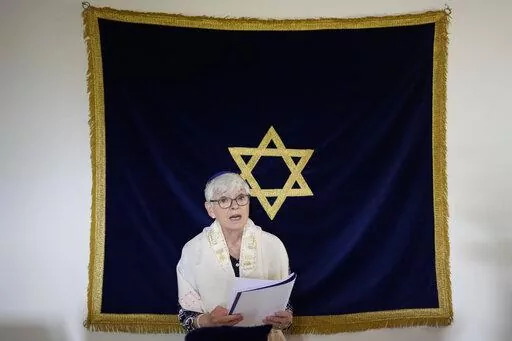 Rabbi Barbara Aiello reads prayers in her "Ner Tamid del Sud" (The Eternal Light of the South) synagogue in Serrastretta, southern Italy, Friday, July 8, 2022. From a rustic, tiny synagogue she fashioned from her family's ancestral home in this mountain village, American rabbi Aiello is keeping a promise made to her Italian-born father: to reconnect people in this southern region of Calabria to their Jewish roots, links nearly severed five centuries ago when the Inquisition forced Jews to conver