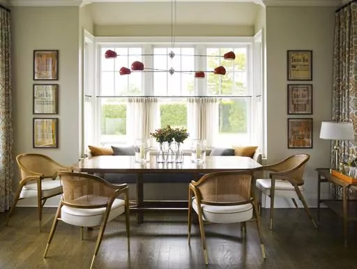 This image provided by Mendelson Group shows designer Gideon Mendelson's home in Sagaponack, New York. Mendelson framed some inexpensive yet eye-catching vintage deli signs for a playful element to the dining room. "Slow decorating" embraces a more deliberate approach that prioritizes a personal connection to the stuff we live with. (Eric Piasecki/OTTO via AP)