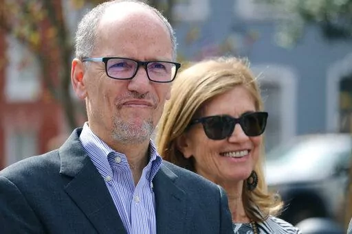 Former Labor Secretary Tom Perez, who is seeking the Democratic nomination for governor, stands with his wife, Ann Marie Staudenmaier, at an event where he outlined a blueprint for advancing women's rights at a news conference in Annapolis, Md., March 22, 2022. One of the best opportunities for Democrats to regain a governor’s office this year is in Maryland, and the race to succeed term-limited Republican Larry Hogan has drawn a crowd of candidates.  (AP Photo/Brian Witte)