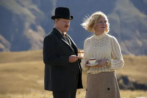 This image released by Netflix shows Jesse Plemons, left, and Kirsten Dunst in a scene from "The Power of the Dog." (Kirsty Griffin/Netflix via AP)