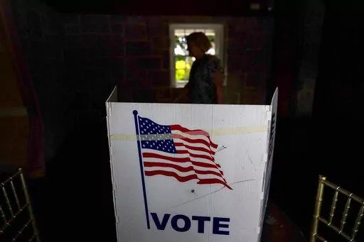 A person waits in line to vote in the Georgia's primary election on May 24, 2022, in Atlanta. More than 1 million voters across 43 states have switched to the Republican Party over the last year, according to voter registration data analyzed by The Associated Press. (AP Photo/Brynn Anderson, File)
