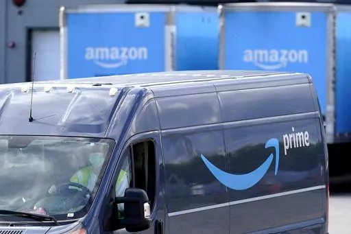 An Amazon Prime logo appears on the side of a delivery van as it departs an Amazon Warehouse location in Dedham, Mass., Oct. 1, 2020. Amazon Prime Day kicks off on Tuesday, July 11, 2023. And, once again, experts are warning consumers of scams. (AP Photo/Steven Senne, File)