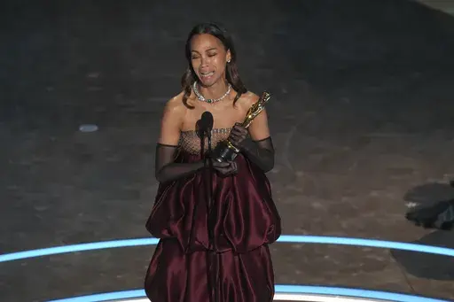 Zoe Saldana accepts the award for best performance by an actress in a supporting role for "Emilia Perez during the Oscars on Sunday, March 2, 2025, at the Dolby Theatre in Los Angeles. (AP Photo/Chris Pizzello)