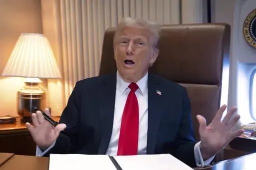 President Donald Trump speaks to reporters aboard Air Force One as he travels to New Orleans, Feb. 9, 2025. (AP Photo/Ben Curtis, File)