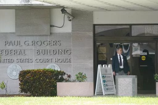 A security guard stands outside the Paul G. Rogers Federal Building and U.S. Courthouse, Thursday, Sept. 1, 2022, in West Palm Beach, Fla. A federal judge heard arguments Thursday on whether to appoint an outside legal expert to review government records seized by the FBI last month in a search of former President Donald Trump's Florida home. There was no immediate ruling. (AP Photo/Wilfredo Lee)