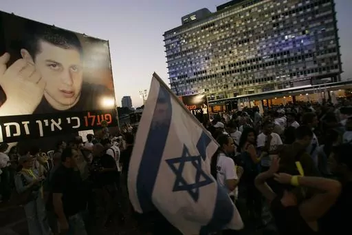 Israelis attend a demonstration calling for the release of abducted Israeli soldier Gilad Shalit, July 22, 2008, in Tel Aviv, Israel. Hamas militants seized Shalit in a cross-border raid on June 25, 2006, killing two other members of his tank crew. Hamas' 2006 seizure of Shalit consumed Israeli society for years — a national obsession that prompted Israel to heavily bombard the Gaza Strip and ultimately release over 1,000 Palestinian prisoners, many of whom had been convicted of deadly attacks