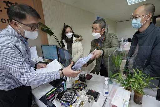 Peter Møller, second from right, attorney and co-founder of the Danish Korean Rights Group, submits the documents at the Truth and Reconciliation Commission in Seoul, South Korea, Nov. 15, 2022. South Korea’s Truth and Reconciliation Commission said Thursday, June 8, 2023 it will investigate 237 more cases of South Korean adoptees who suspect their family origins were manipulated to facilitate their adoptions in Europe and the United States. (AP Photo/Ahn Young-joon, File)