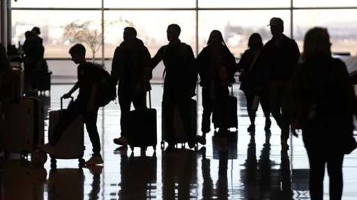 People pass through Salt Lake City International Airport Wednesday, Jan. 11, 2023, in Salt Lake City. Summer can be an expensive time to travel. Though it’s usually best to pay with cash for any nonessentials, like a vacation, there are financing options available if you don’t have the funds to cover your travel expenses outright. (AP Photo/Rick Bowmer, File)