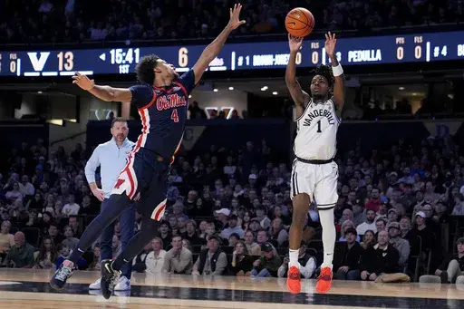 Vanderbilt guard Jason Edwards (1) shoots the ball past Mississippi forward Jaemyn Brakefield (4) during the first half of an NCAA college basketball game Saturday, Feb. 22, 2025, in Nashville, Tenn. (AP Photo/George Walker IV)