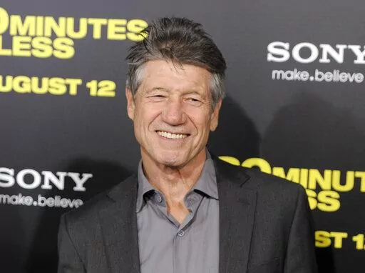 Fred Ward, a cast member in "30 Minutes or Less," poses at the premiere of the film in Los Angeles on Aug. 8, 2011. Ward, a veteran actor who brought a gruff tenderness to tough-guy roles in such films as “The Right Stuff,” “The Player” and “Tremors,” died Sunday, May 8, his publicist Ron Hofmann said Friday, May 13, 2022. He was 79. (AP Photo/Chris Pizzello, File)