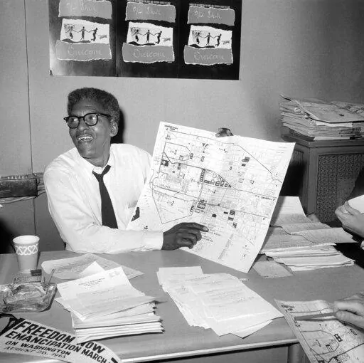 Bayard Rustin, deputy director of the planned march on Washington program, points to a map showing the line of march for the demonstration for civil rights during a news conference in New York on Aug. 24, 1963.   (AP Photo, File)